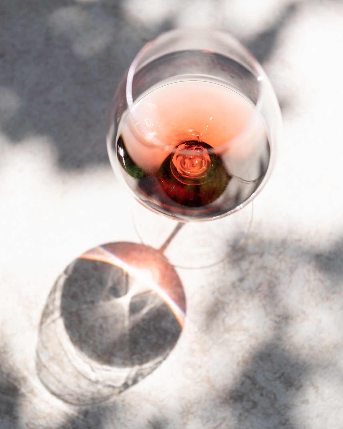 rosé wine in dappled light