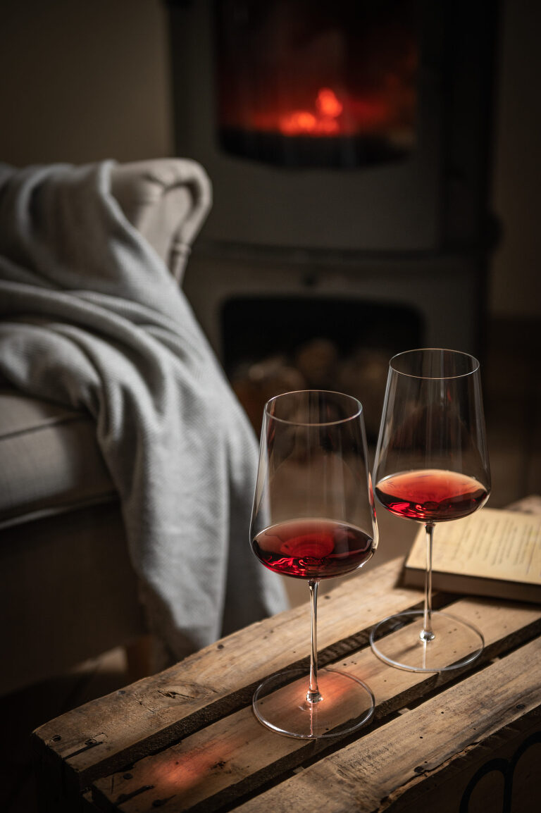 Christina Thiblet Wine photographer - Cosy red wine by the fire on holidays in the french wine country