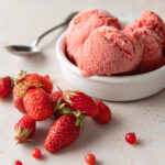 Roasted Strawberry Gelato next to fresh strawberries and red currants from the garden