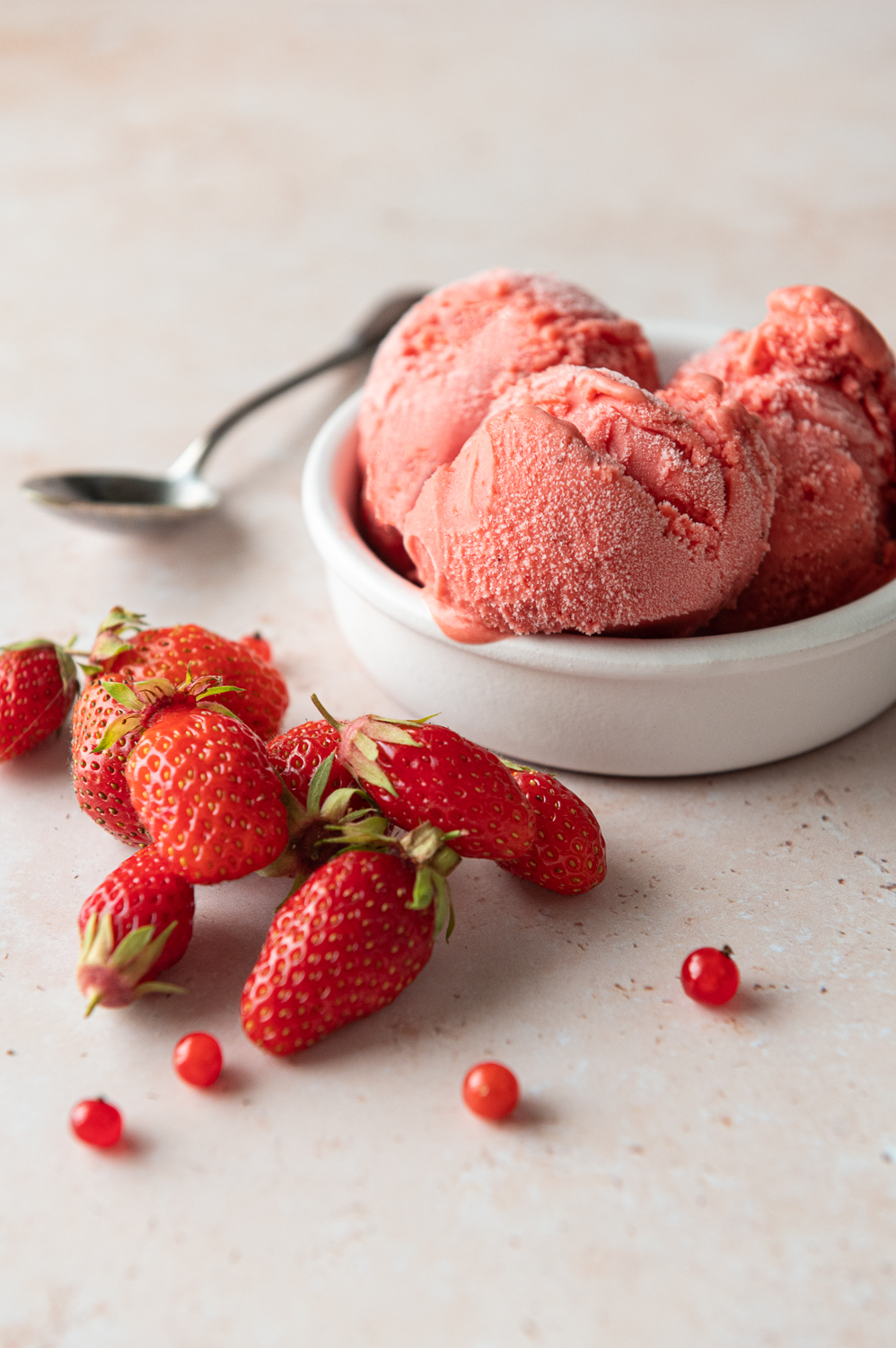 Roasted Strawberry Gelato next to fresh strawberries and red currants from the garden