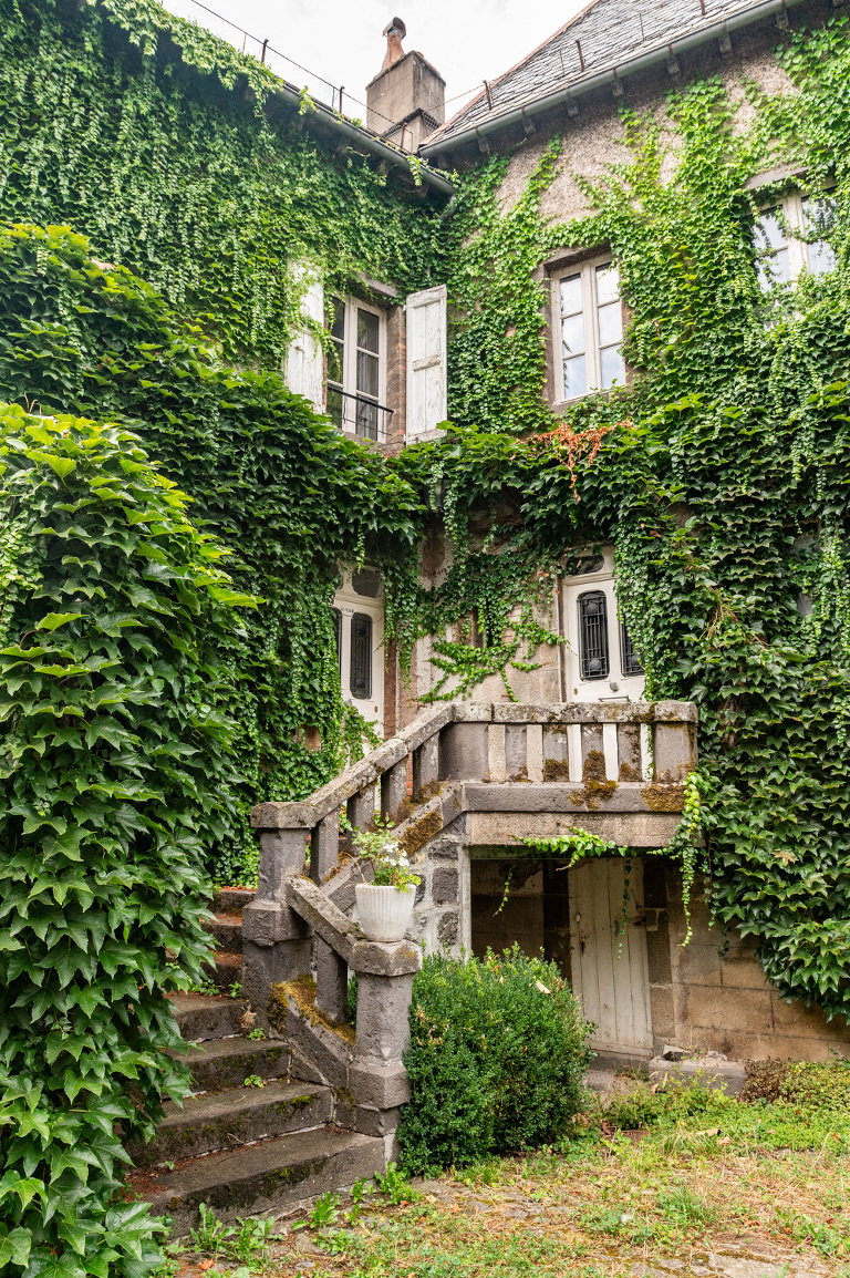 An ivy covered home in Salers, France in Cantal