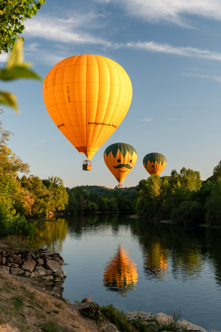 Montgolfières du Perigord hot air balloons touch down in the Dordogne River at La Roque Gageac