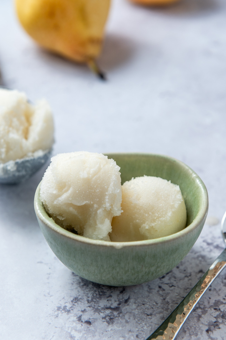 poached pear sorbet in a green bowl at 45 degree angle
