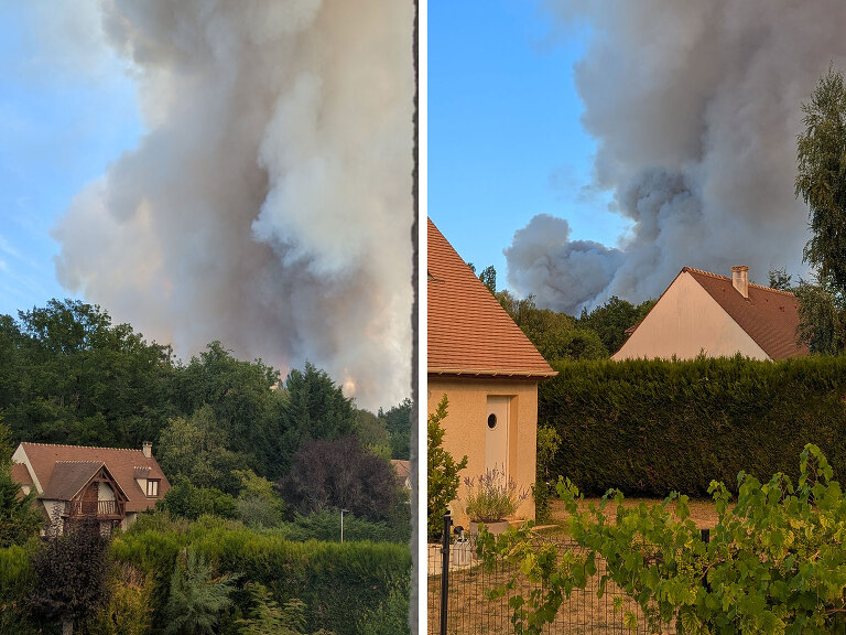 Anxiously watching the billowing smoke from the forest across the street